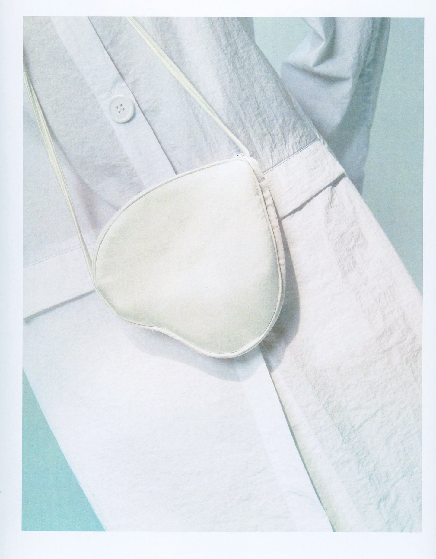 White hearts shape satin bag with two shoulders straps. Shoulder heart bag. FORMA brand shop online