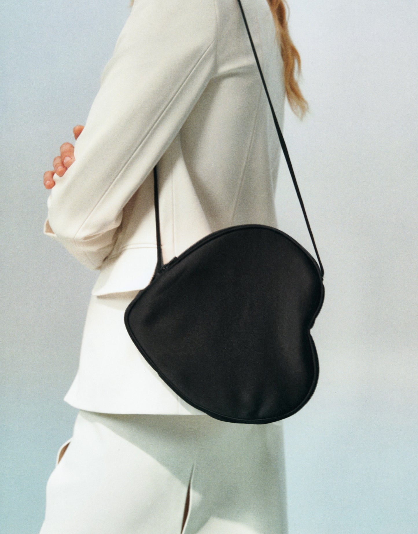 White hearts shape satin bag with two shoulders straps. Shoulder heart bag. FORMA brand shop online