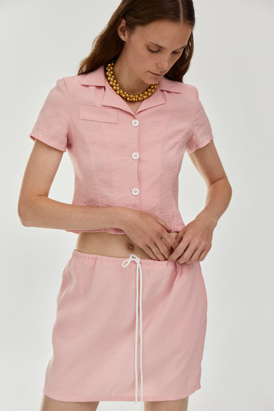Viscose blend skirt featuring a drawstring fastening waist, side pockets and a short length in pink color from FORMA